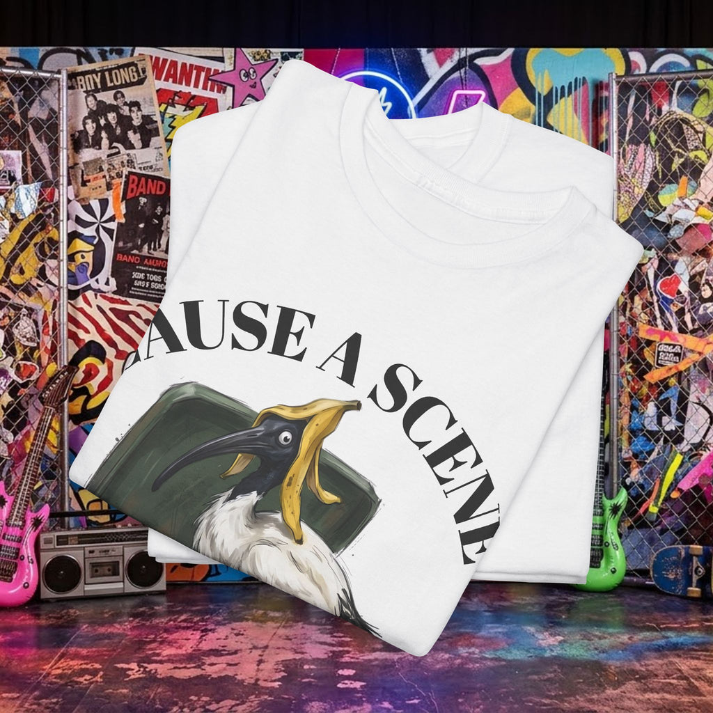 White t-shirt folded flat, “CAUSE A SCENE” ibis in a trash can graphic