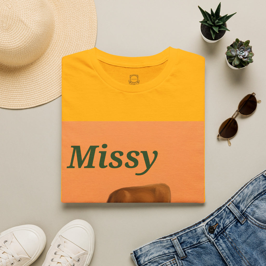 Orange crewneck T-shirt with Missy text and grazing cow graphic