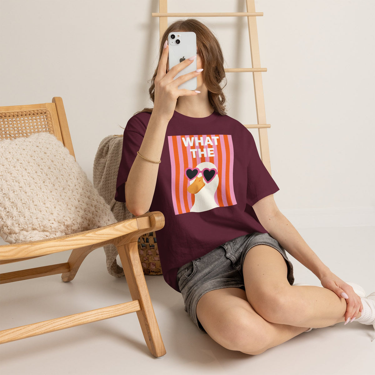 Maroon oversized cotton graphic tee with “WHAT THE” striped portrait and heart sunglasses.