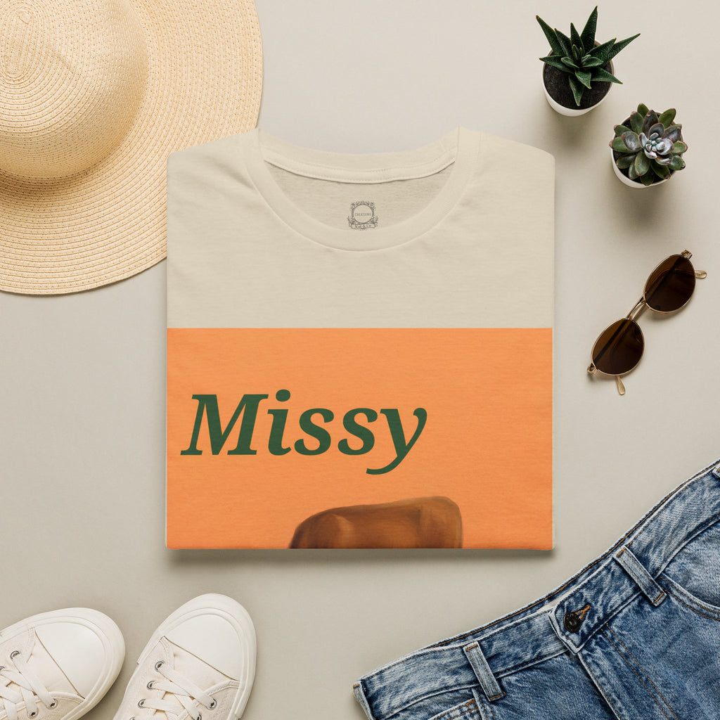 Cream T-shirt with orange 'Missy' square and grazing cow graphic