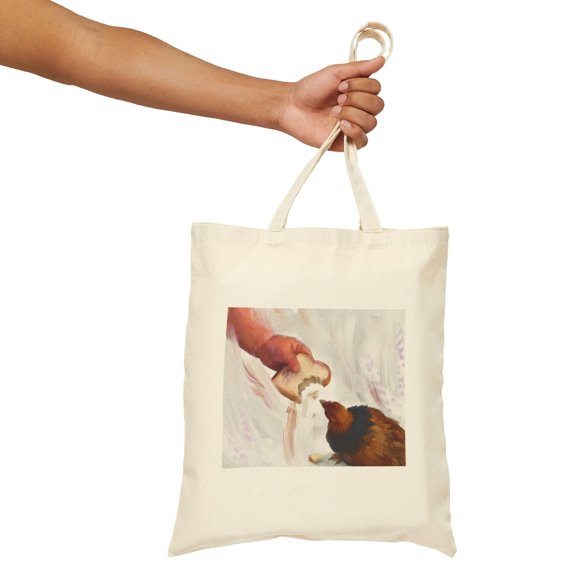 Natural canvas tote bag with vintage hen feeding illustration, held by the top handles.