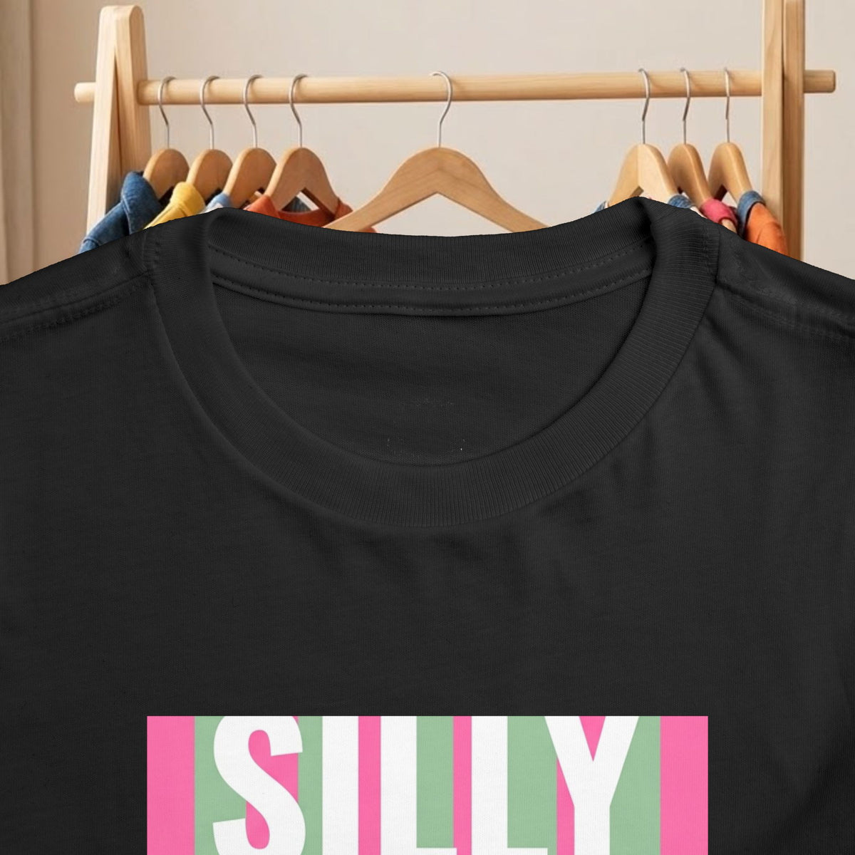 Black toddler tee close-up: crew neck and partial colorful “SILLY” duck print