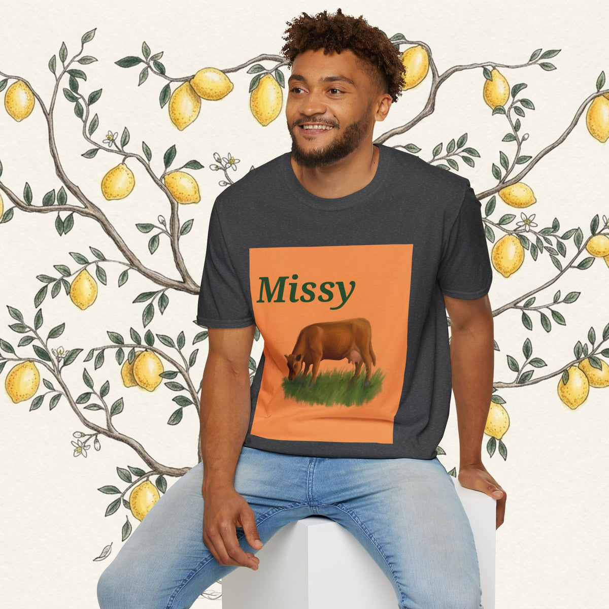 Charcoal T-shirt with orange “Missy” front print and grazing cow illustration