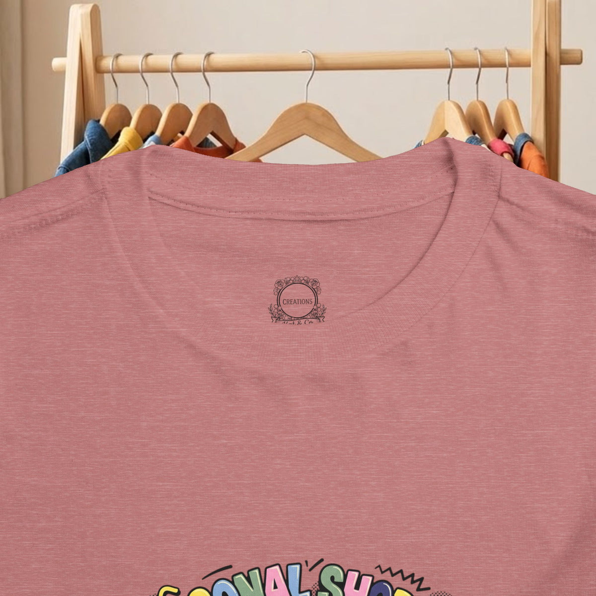 Maroon toddler tee close-up of neckline badge and partial bottom graphic