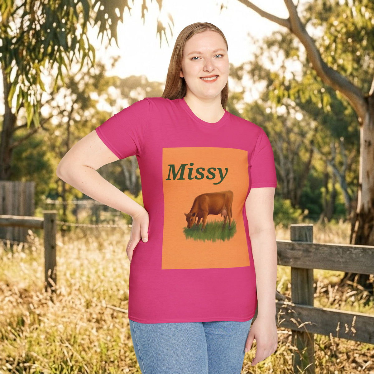 Pink crewneck t-shirt with grazing cow graphic and “Missy” on front, outdoors