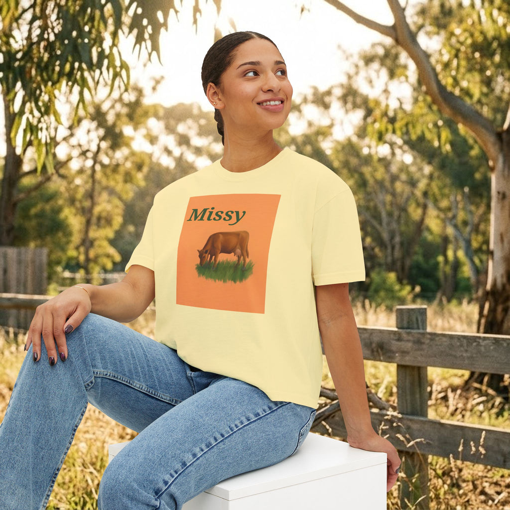 Women’s boxy tee in butter yellow with “Missy” cow graphic on the front.