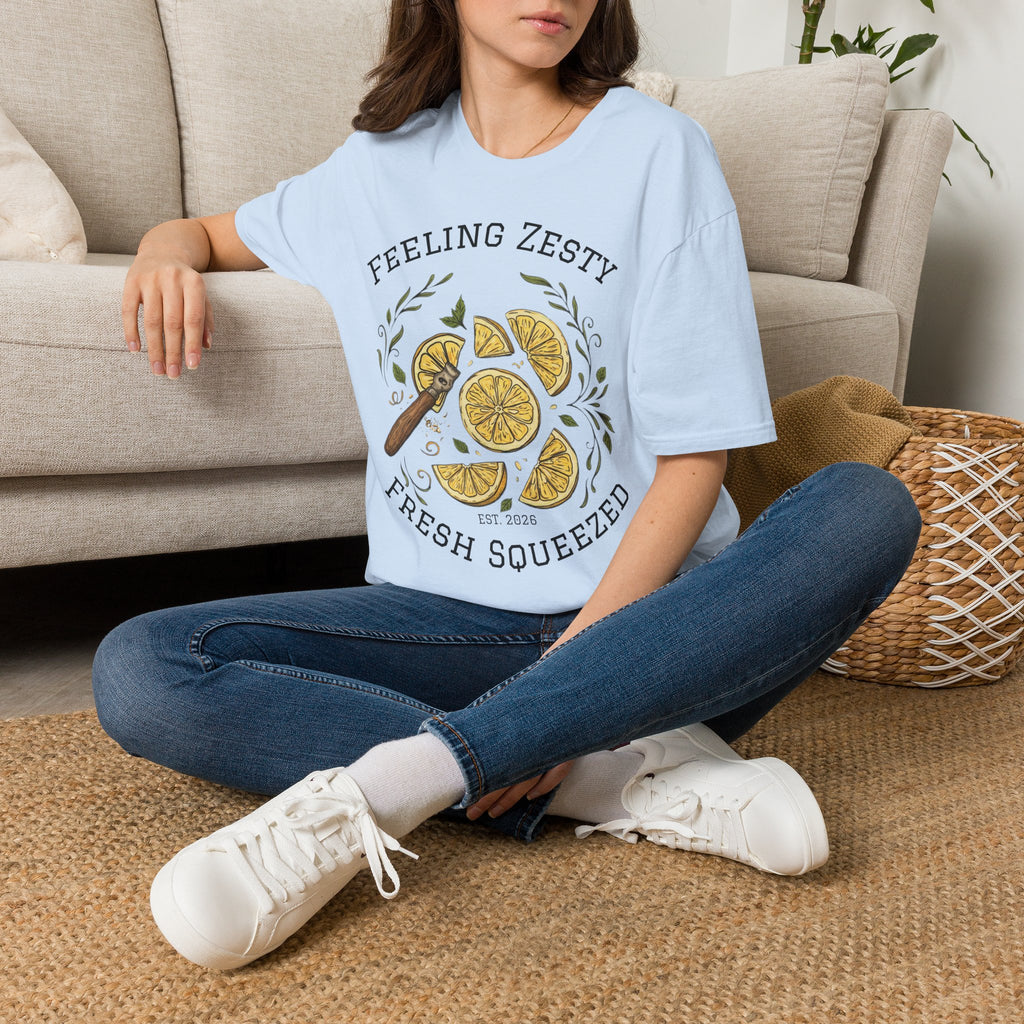 Light blue crewneck graphic tee worn with jeans; "FEELING ZESTY" and "FRESH SQUEEZED"