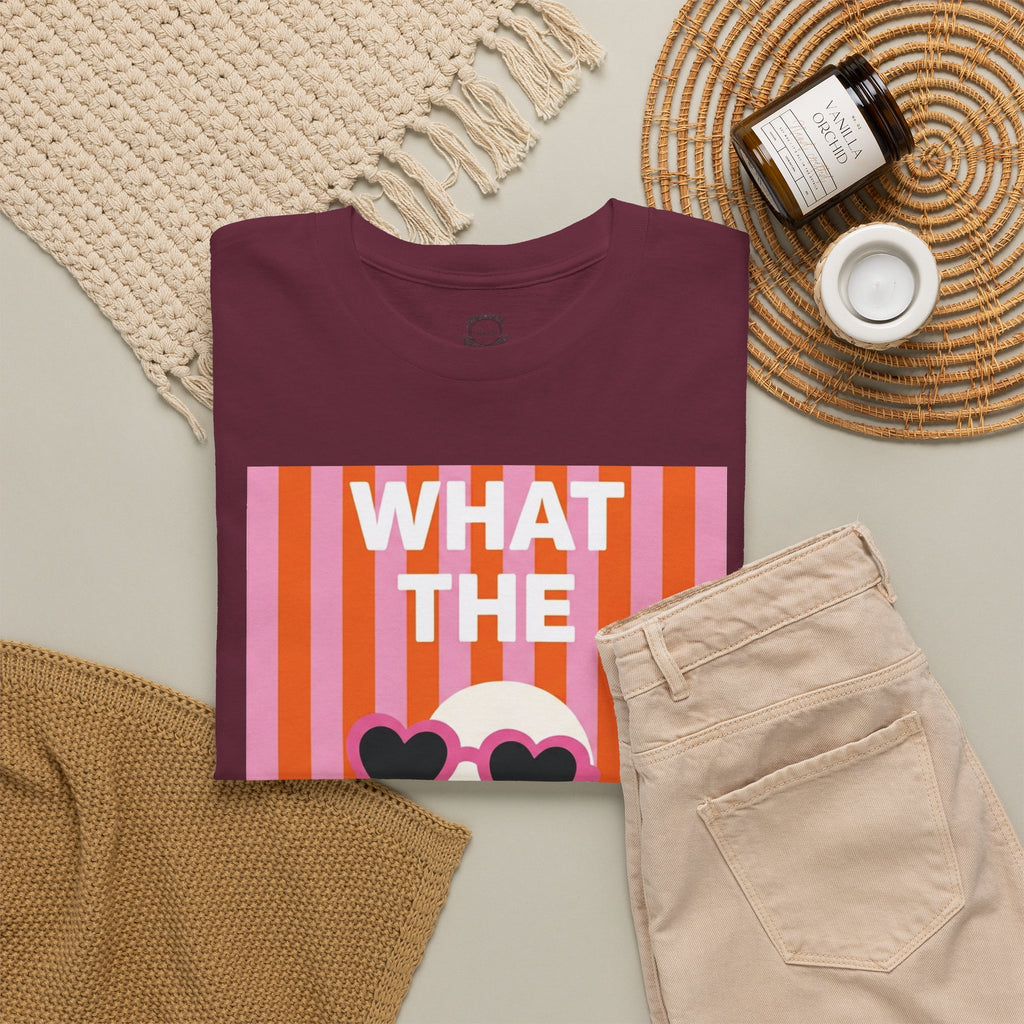Maroon cotton graphic tee flat lay with “WHAT THE” striped portrait and heart sunglasses print.