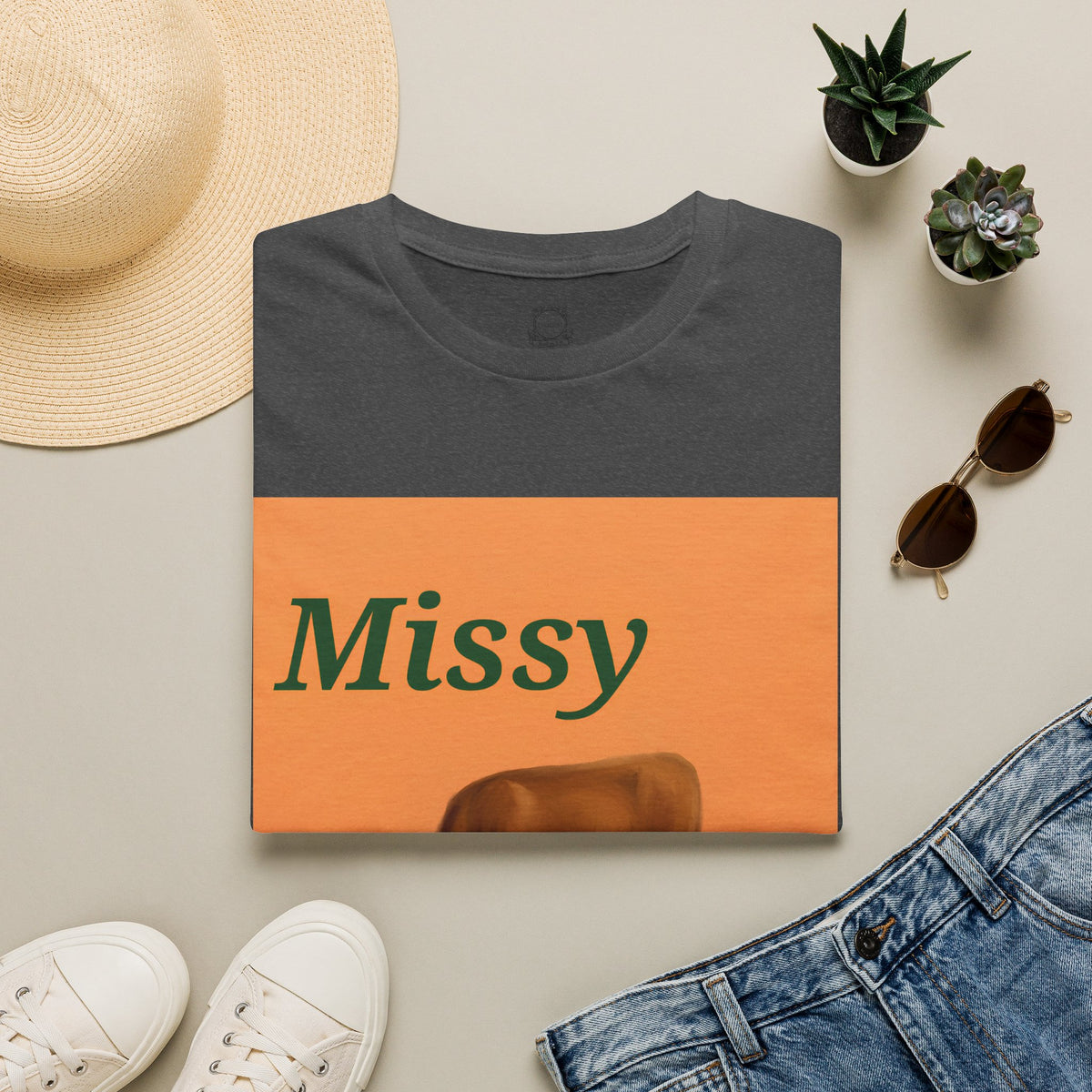Charcoal T-shirt with orange “Missy” front graphic and grazing cow