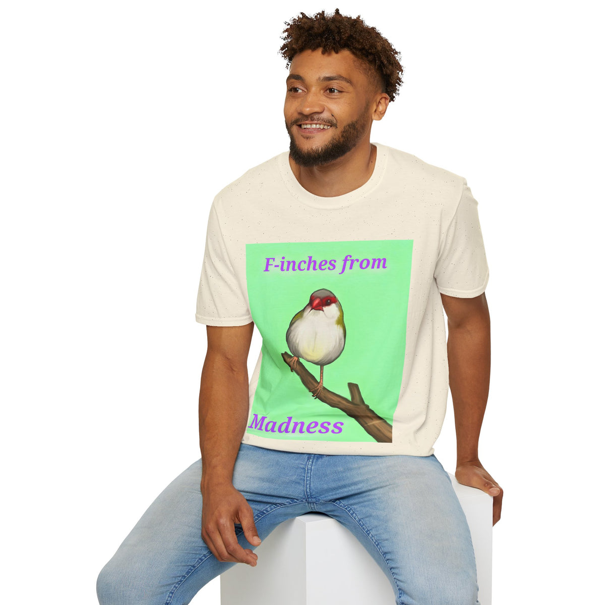 White t-shirt with green panel bird illustration graphic worn by a man