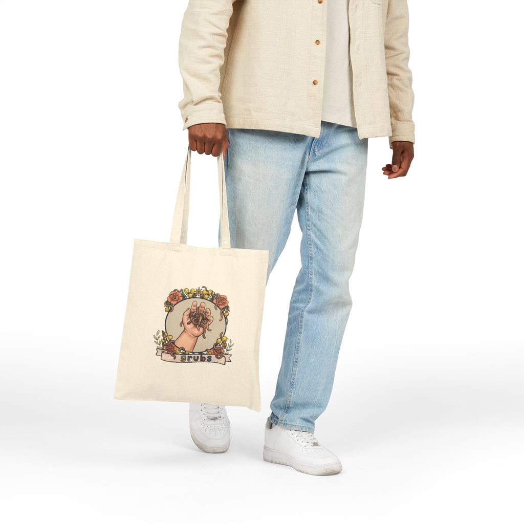 Natural canvas tote bag with colorful hand-and-grubs graphic, long handles