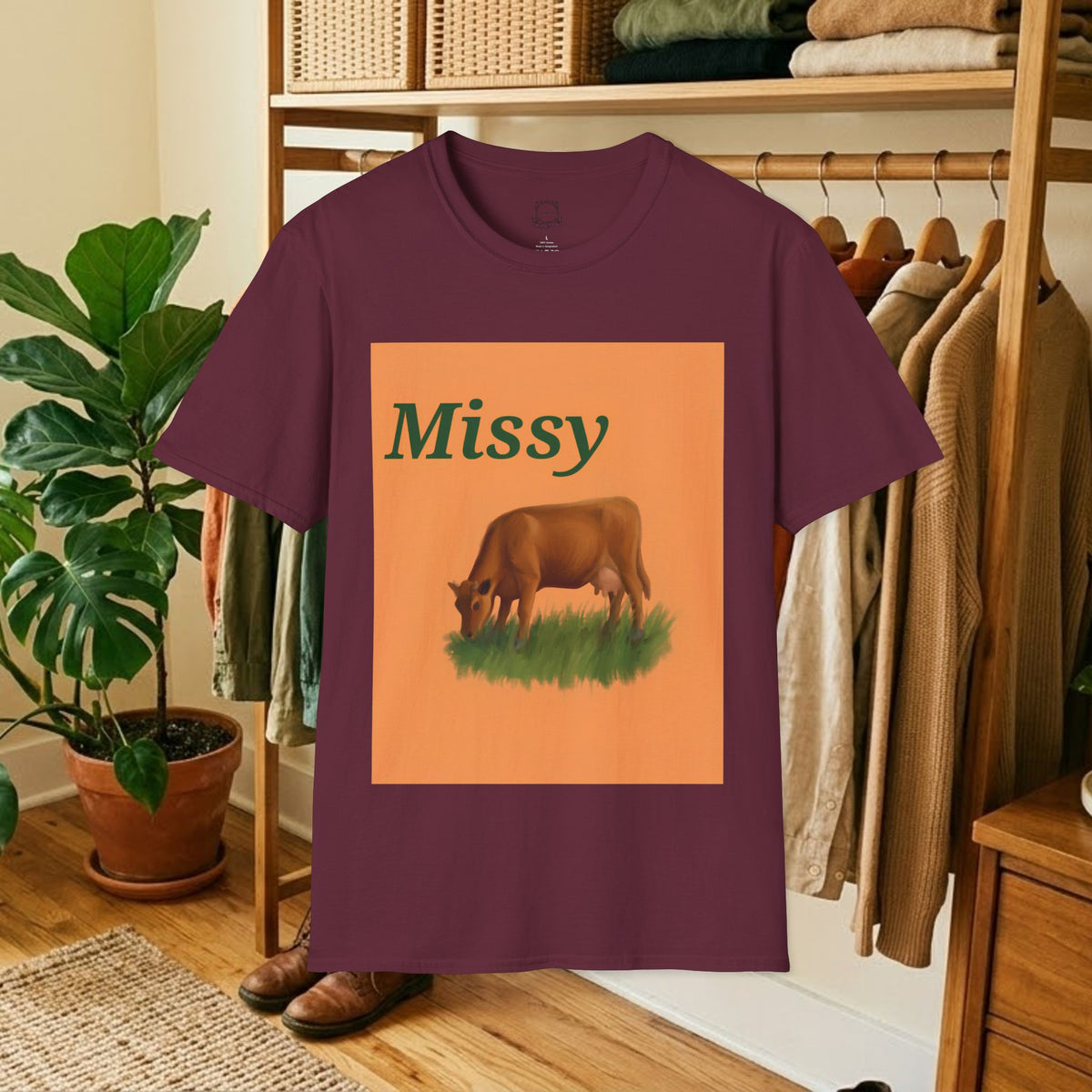 Maroon crew-neck t-shirt with orange square “Missy” grazing cow graphic