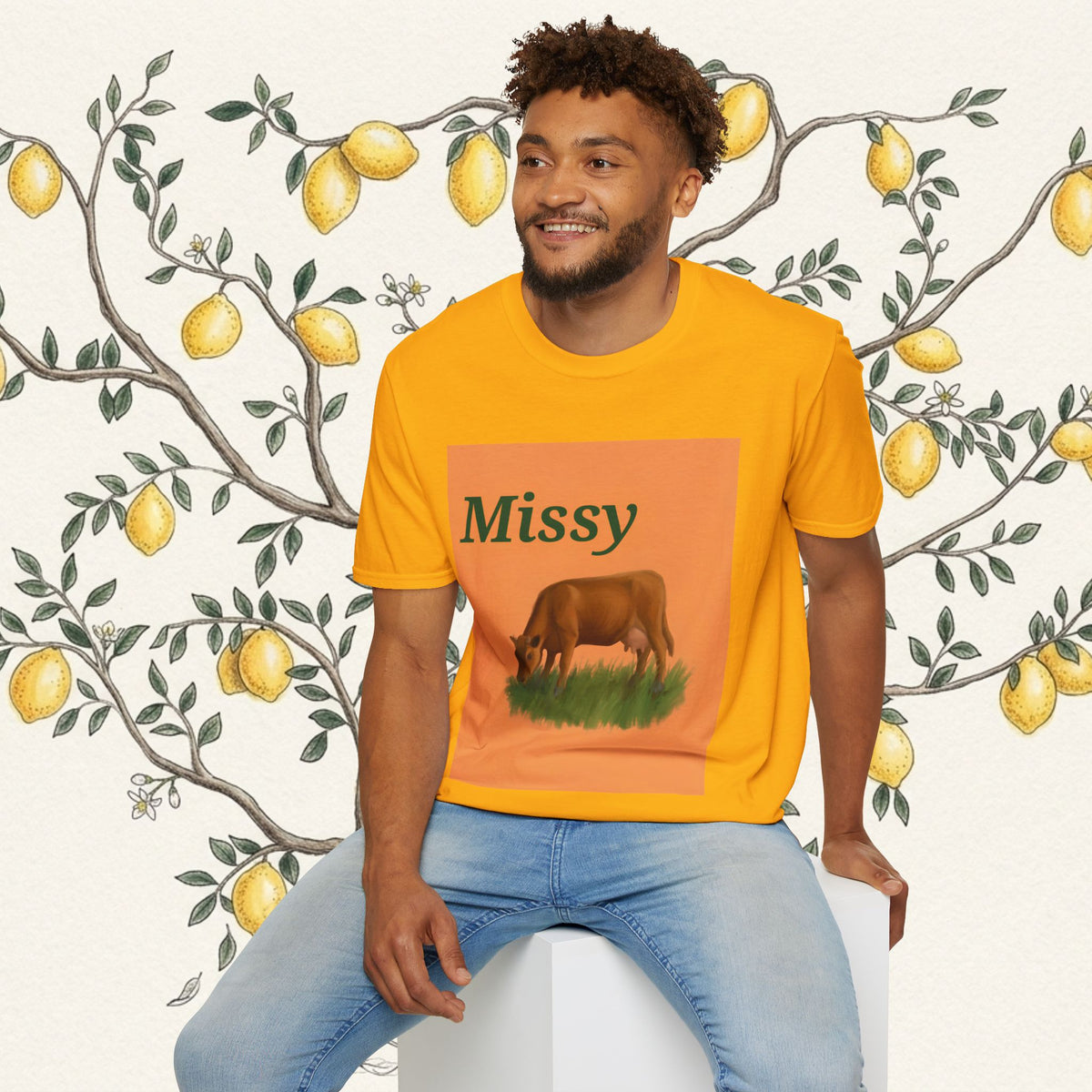 Orange crewneck T-shirt with Missy text and grazing cow graphic on square print