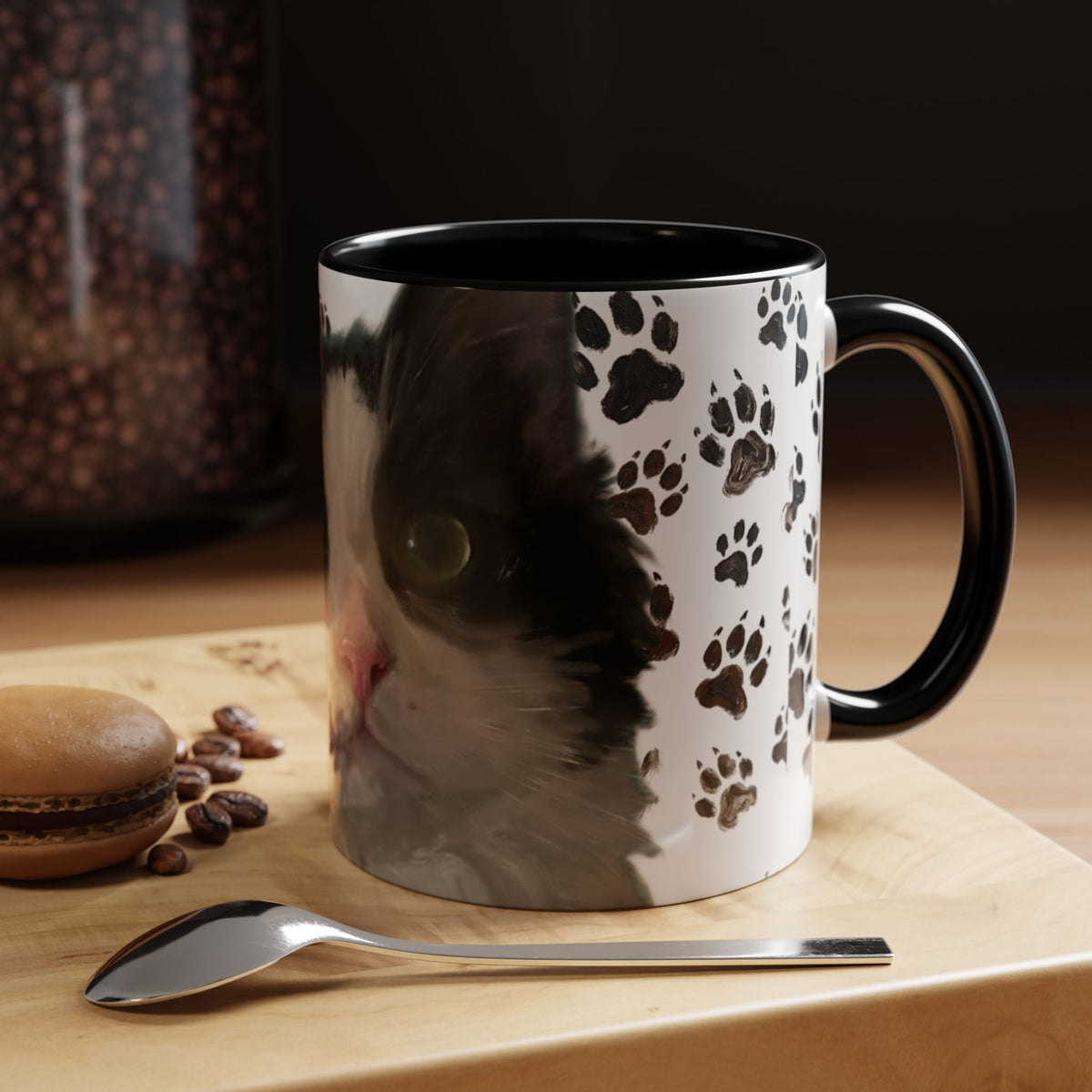 Black cat face accent coffee mug with paw print pattern, white body, black handle