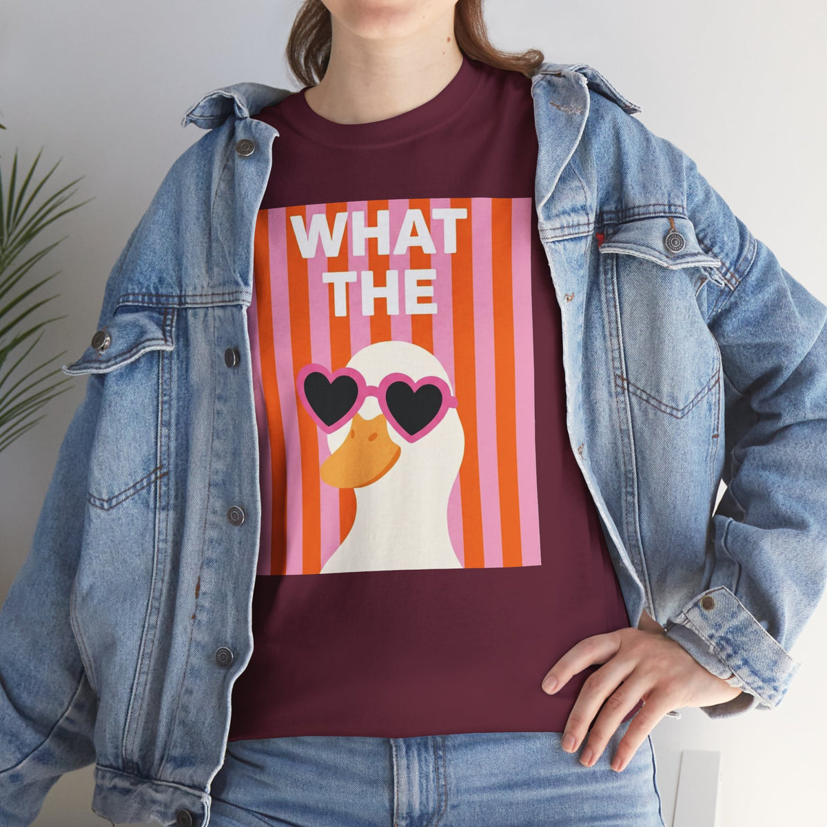 Maroon cotton graphic tee with “WHAT THE” striped portrait and heart sunglasses under jacket.