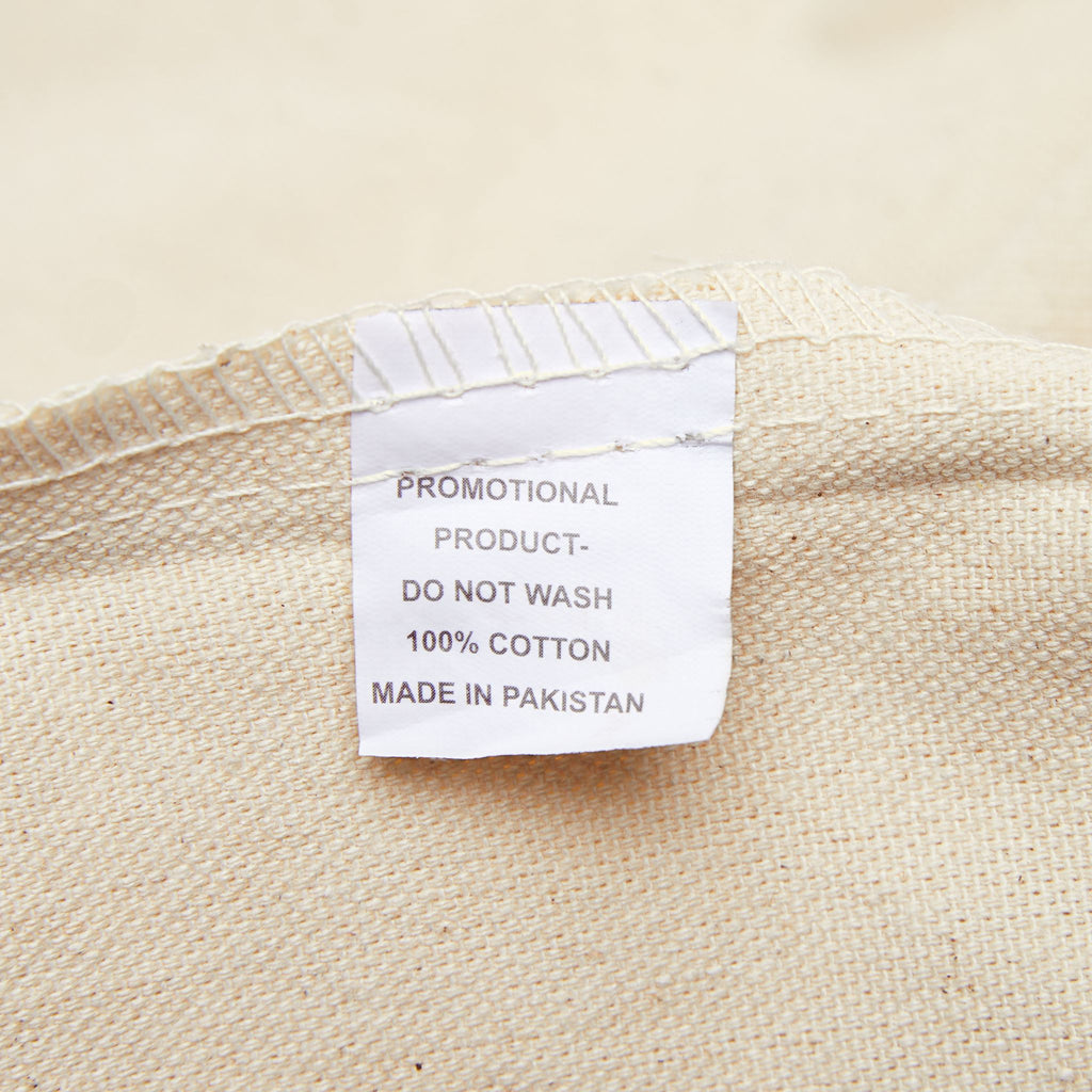 Natural canvas tote bag fabric label tag with cotton and care text