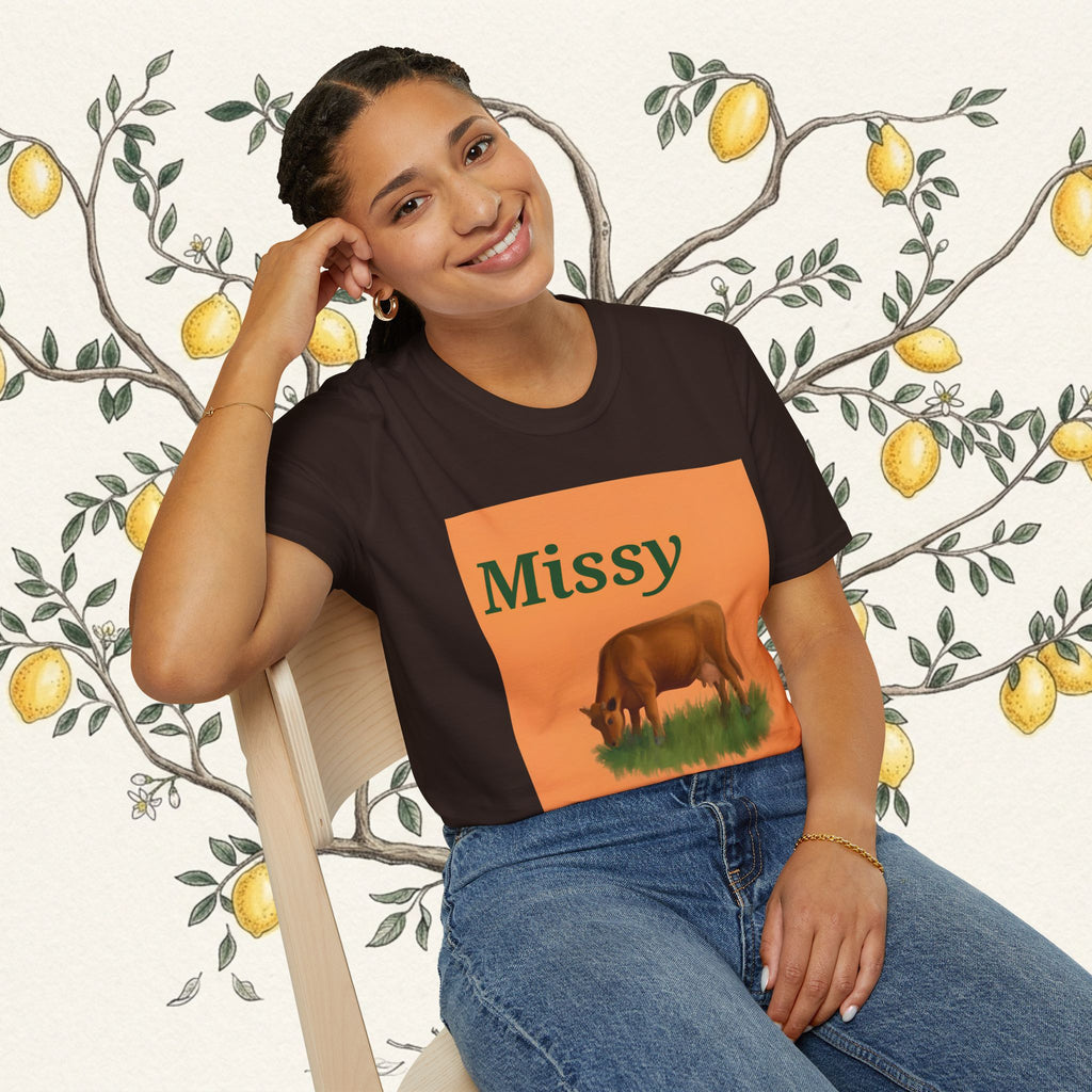 Dark brown cow graphic T-shirt with orange square print, seated model pose