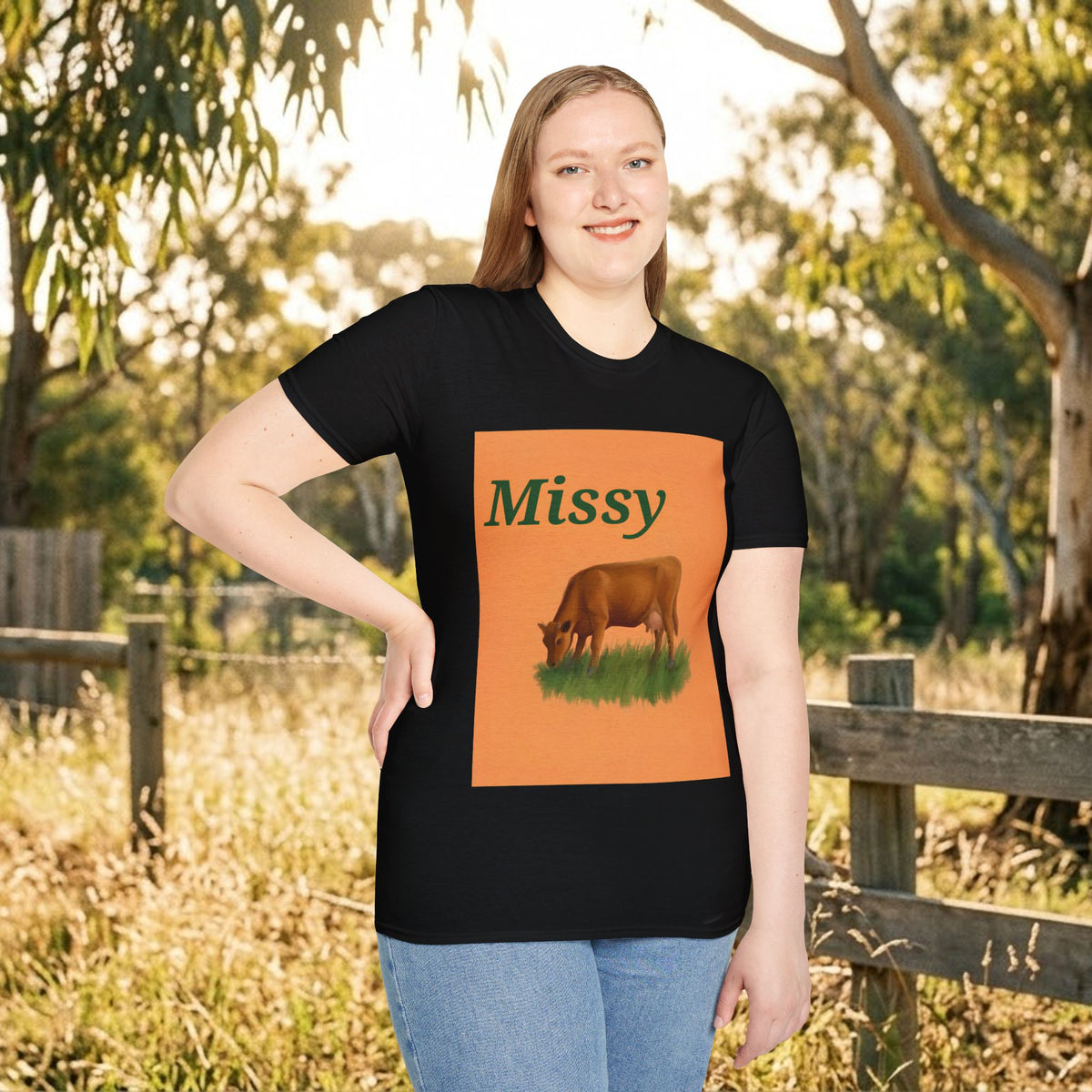 Black cow graphic t-shirt with 'Missy' and grazing cow artwork, outdoor full front
