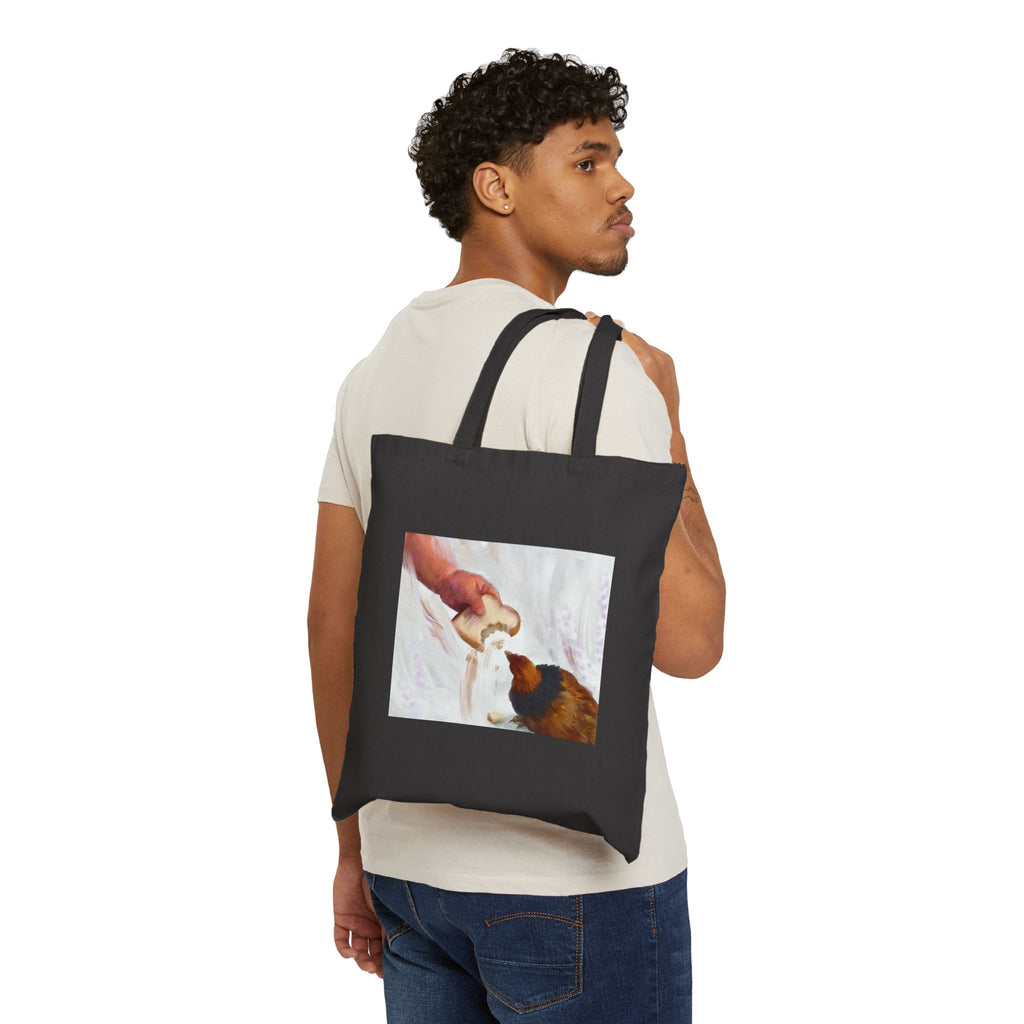 Black canvas tote bag with front illustration panel and two carrying handles