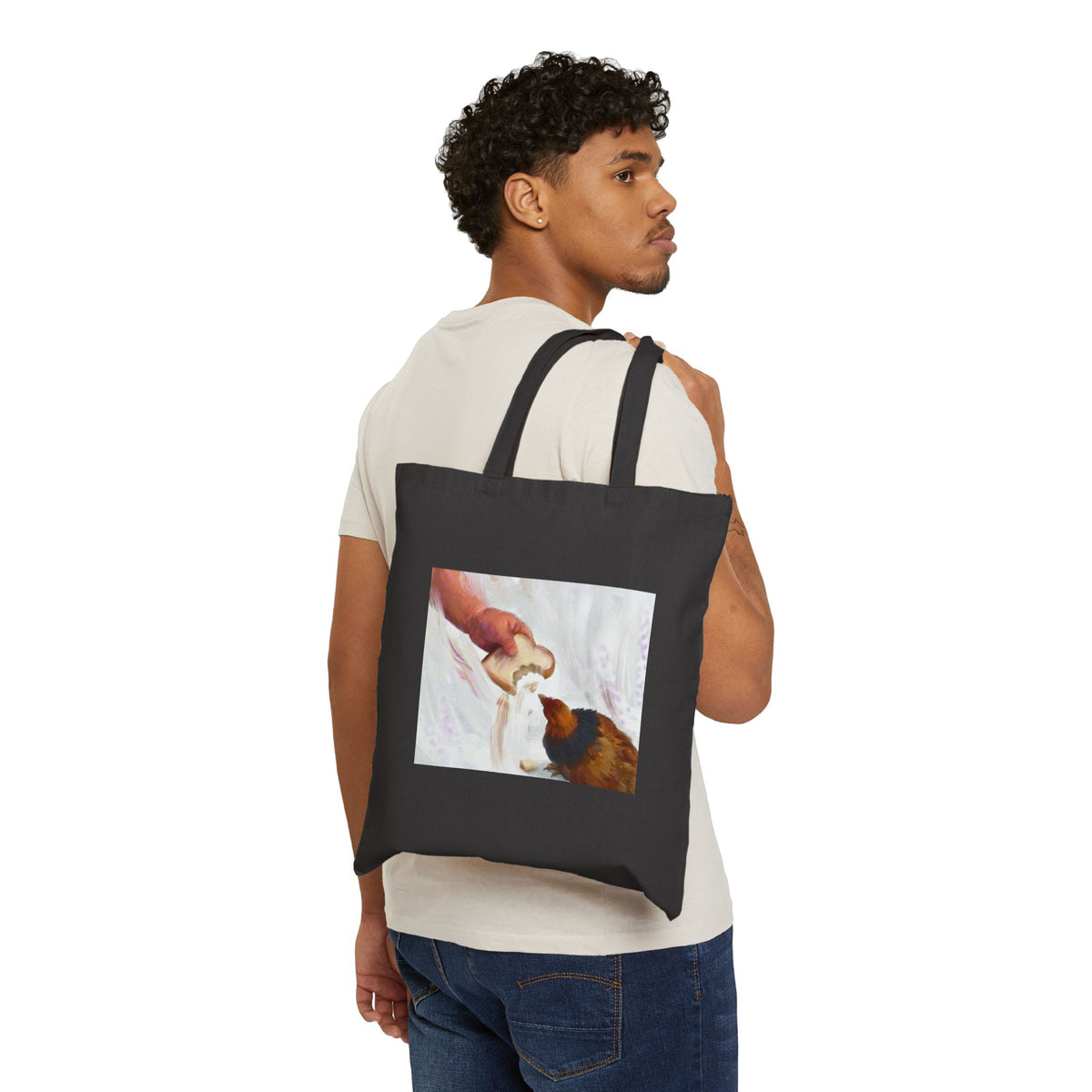 Black canvas tote bag with front illustration panel and two carrying handles