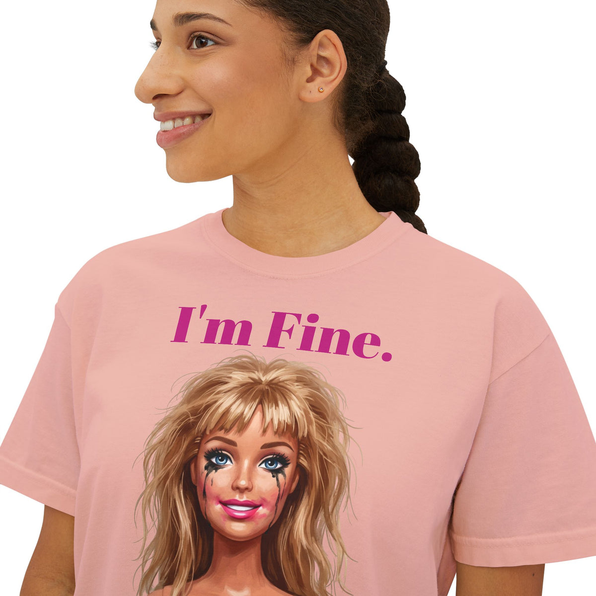 Boxy pink graphic tee with “I'm Fine.” text and doll face print, crew neck.