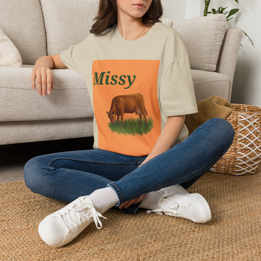 Cream crew-neck T-shirt with orange 'Missy' graphic square and grazing cow