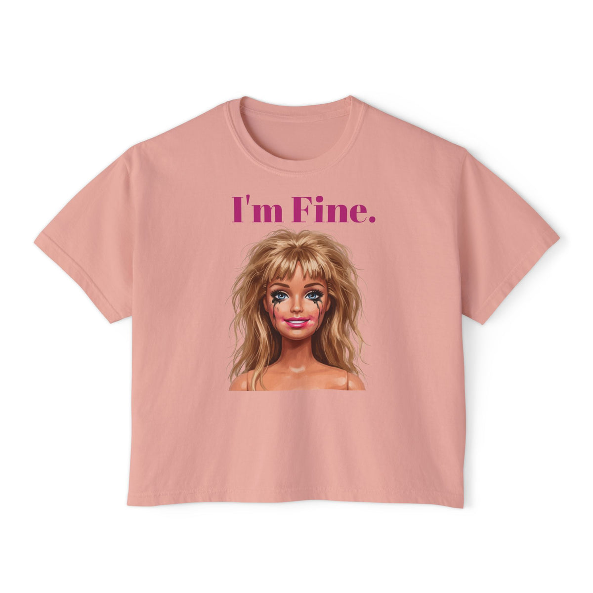 Boxy peach-pink graphic tee with “I'm Fine.” text and doll face print, crew neck.