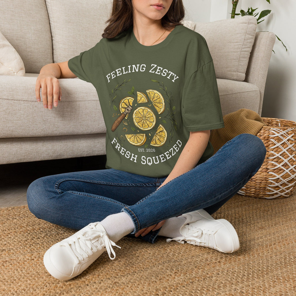 Olive green crewneck tee worn with “FEELING ZESTY” and “FRESH SQUEEZED” citrus graphic