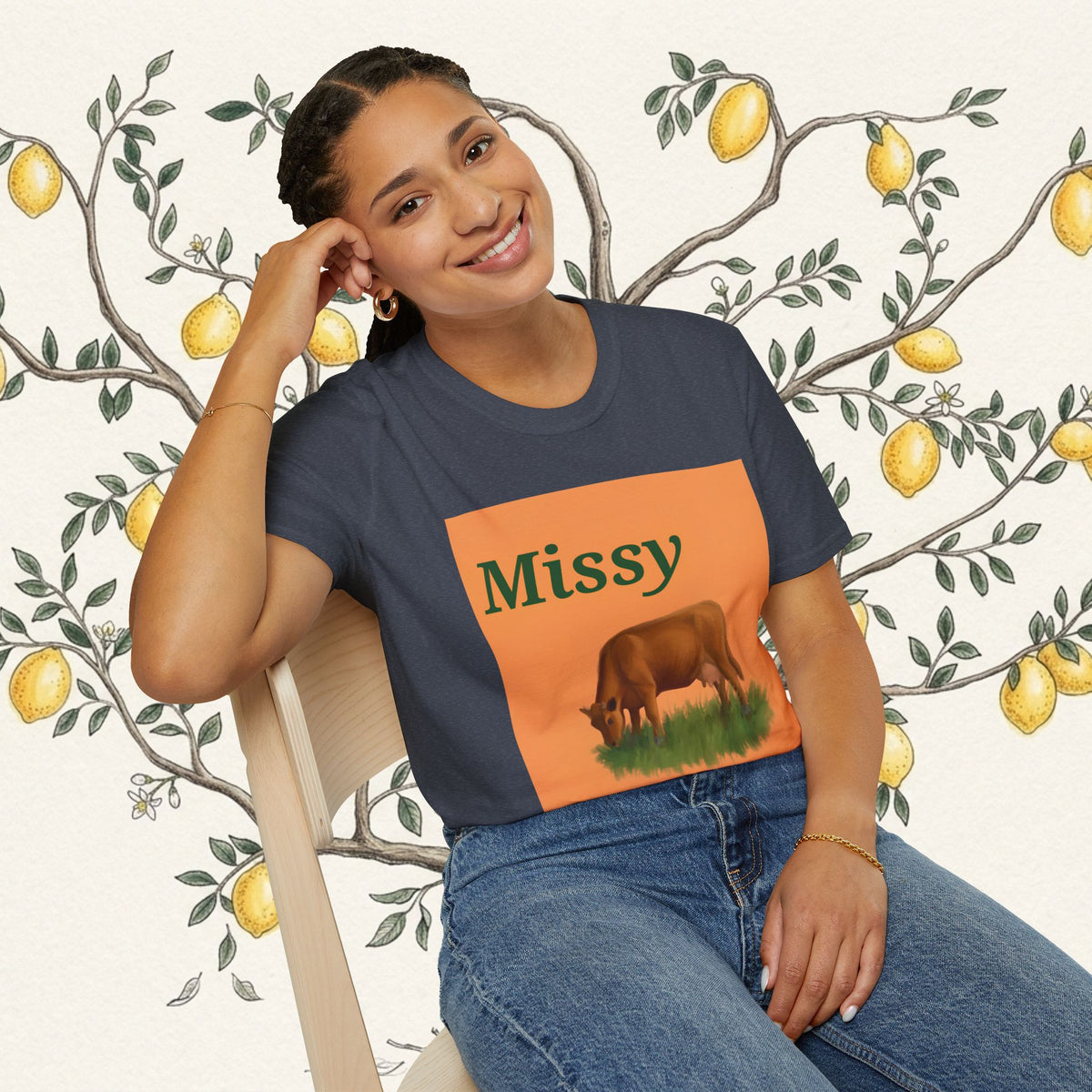 Navy crew-neck T-shirt with orange Missy graphic and grazing cow illustration