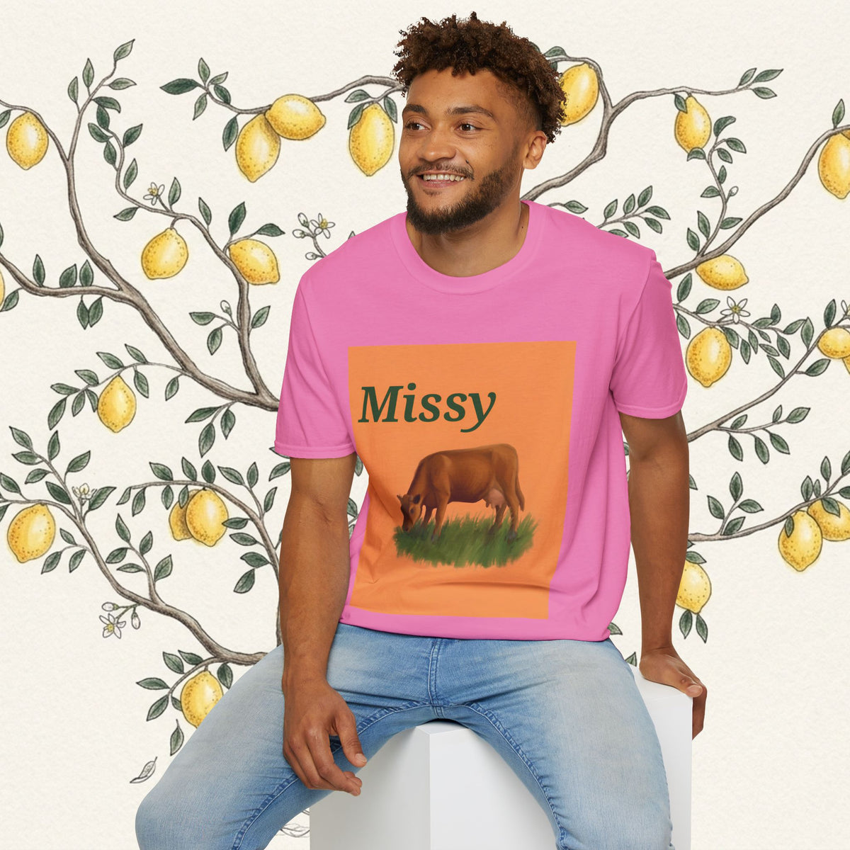 Pink crewneck t-shirt on model with grazing cow graphic and “Missy” lettering