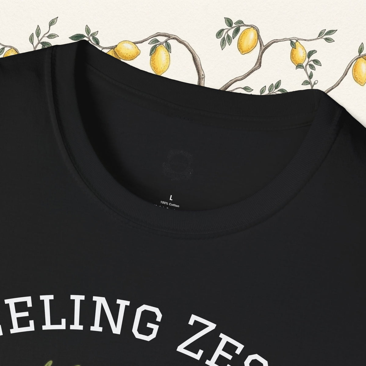 Black crew-neck tee close-up with “FEELING ZESTY” text across the chest