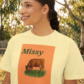 Women’s boxy graphic tee in butter yellow with 'Missy' cow illustration on front