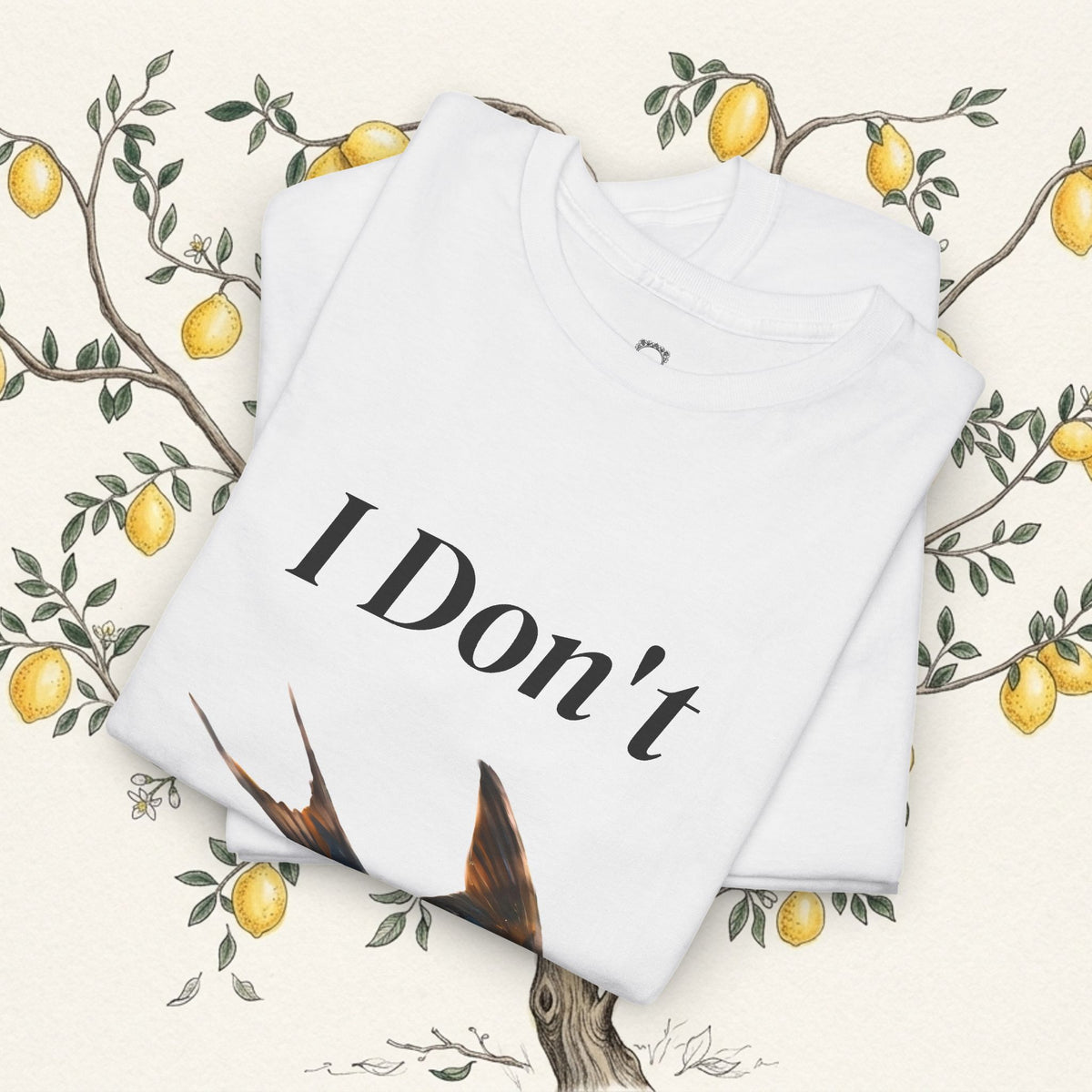 White graphic T-shirt folded view with “I Don’t” text and bird illustration