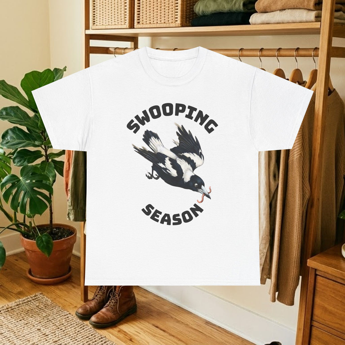 White t-shirt with black bird graphic and "SWOOPING SEASON" text