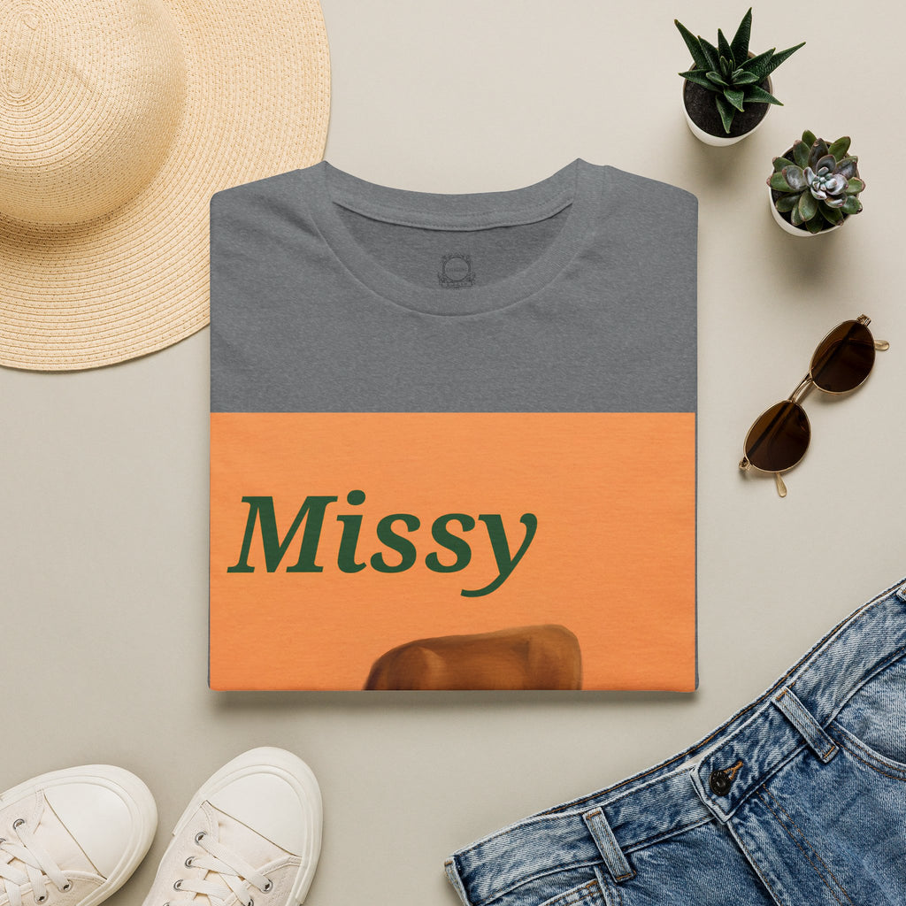 Dark gray t-shirt with orange graphic panel showing Missy text and grazing cow