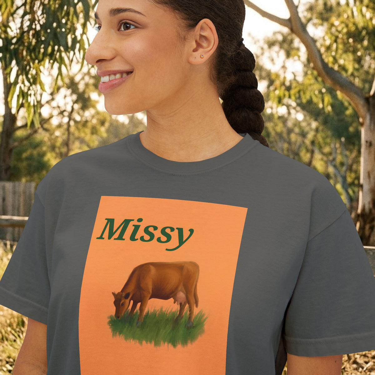 Women’s boxy graphic tee in dark gray with 'Missy' cow illustration on front