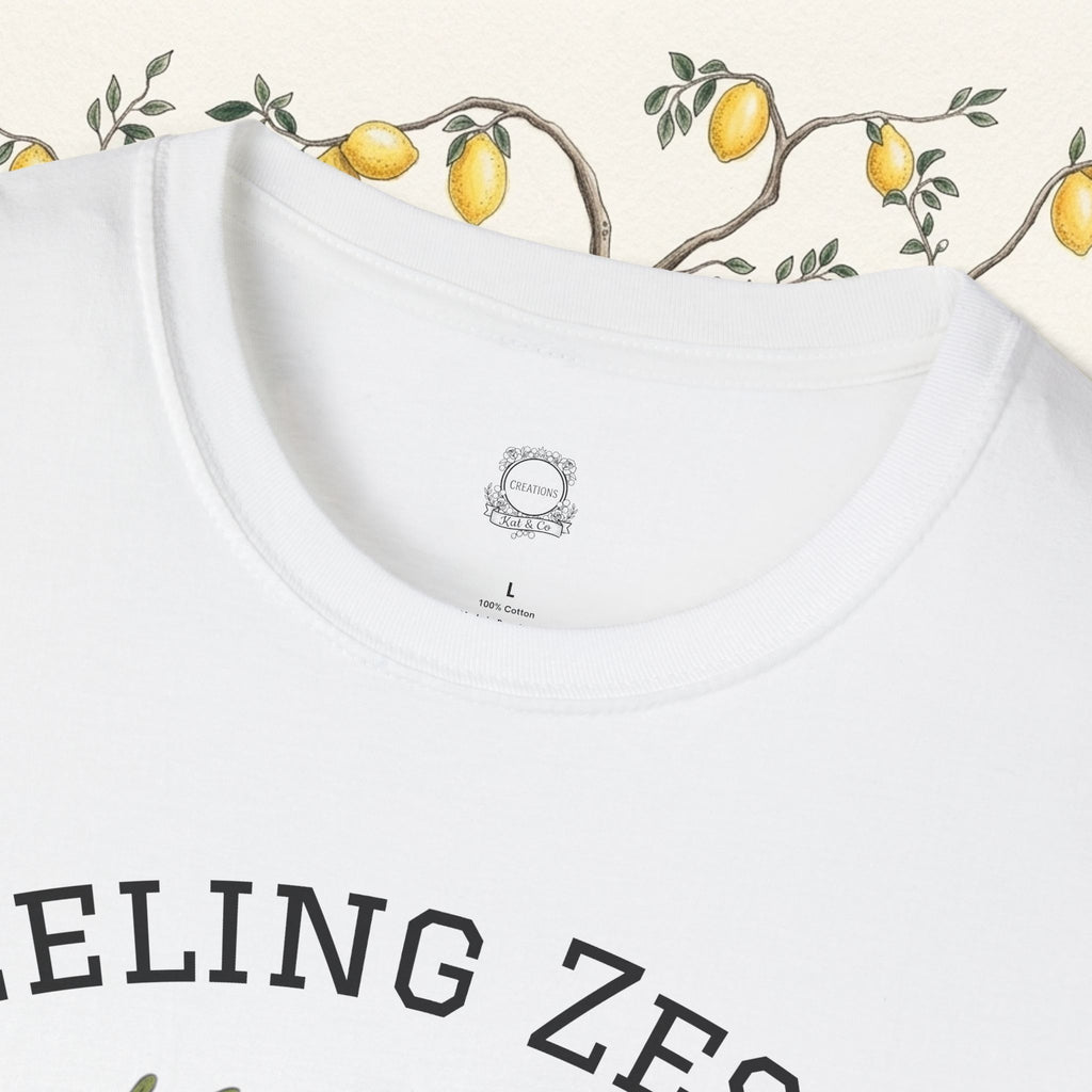 White crewneck tee close-up of collar, tag, and partial "Feeling Zesty" text