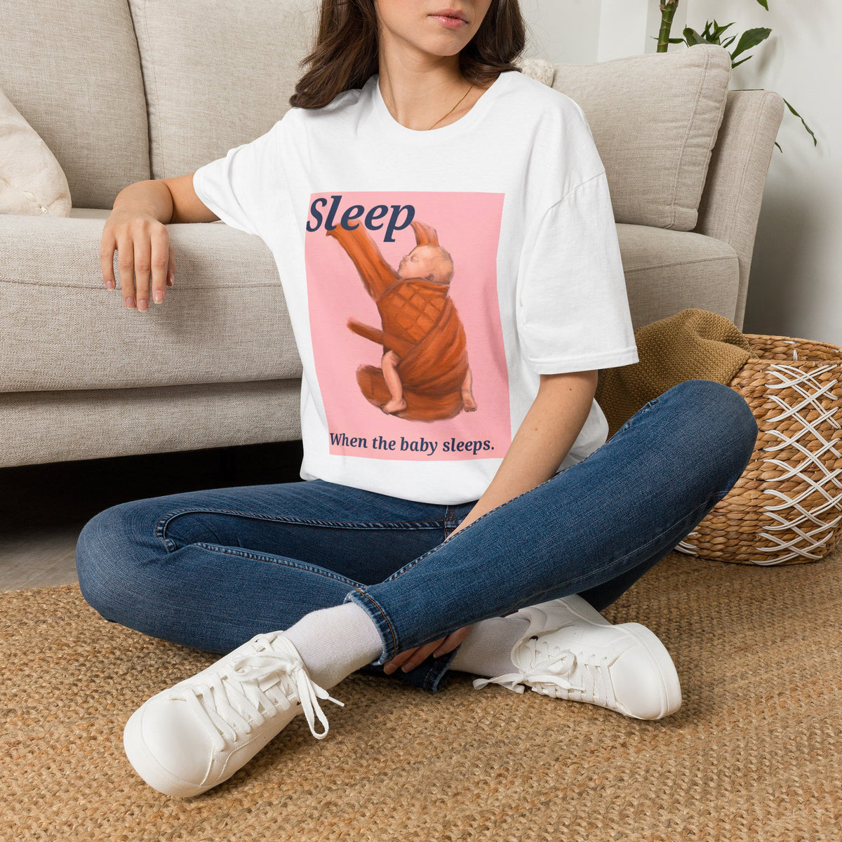 White baby graphic t-shirt worn by model with 'Sleep' sleeping infant illustration