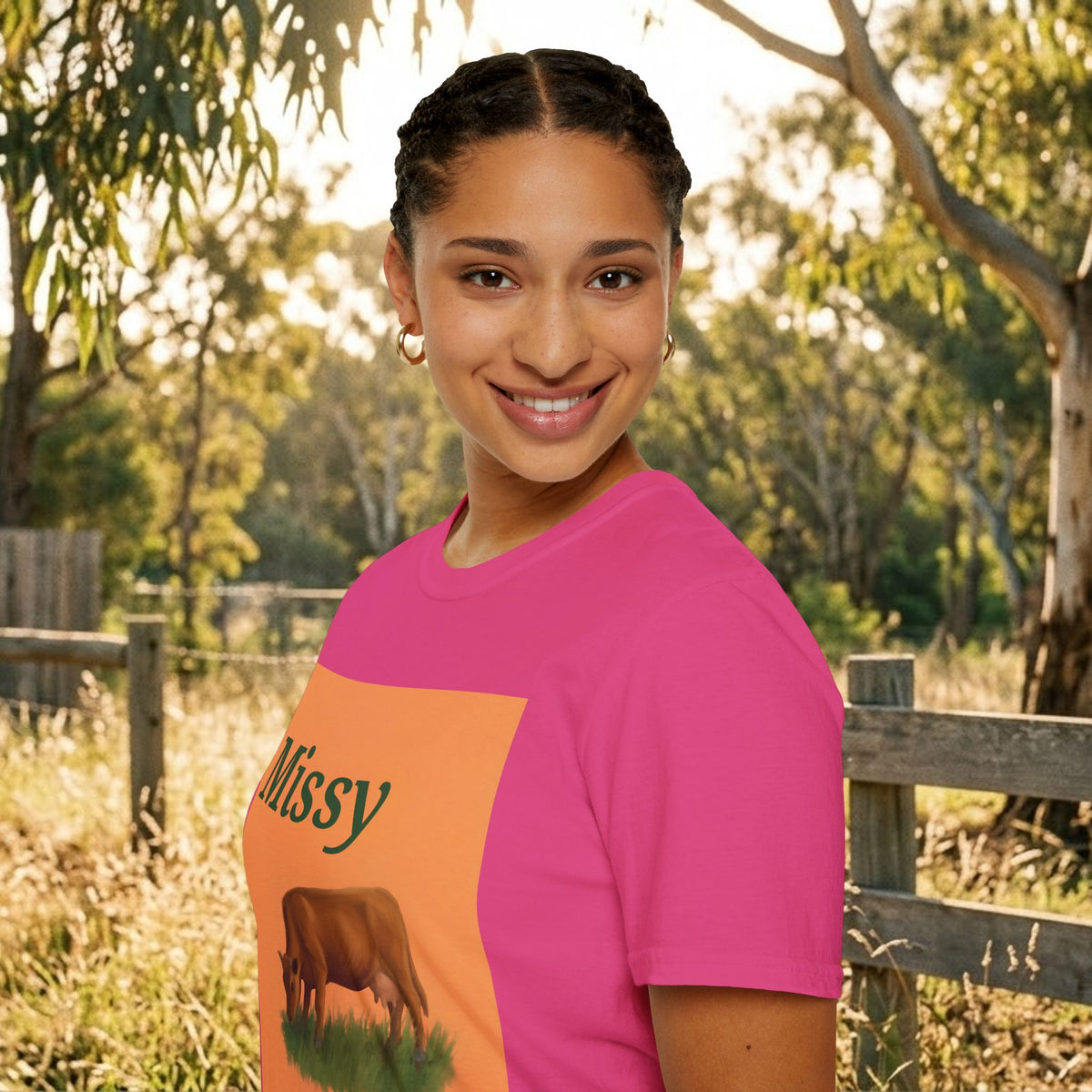 Pink t-shirt shown at angle with orange cow graphic and “Missy” lettering