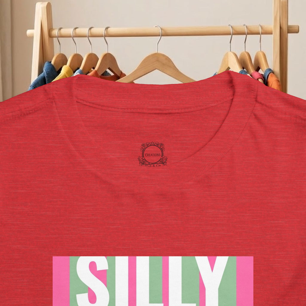 Toddler red tee close-up: small back logo and top of colorful “SILLY” print