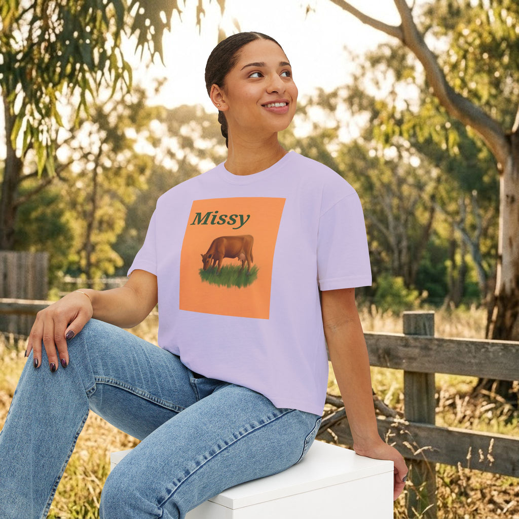 Lavender boxy T-shirt with cow graphic and “Missy” text on the chest.