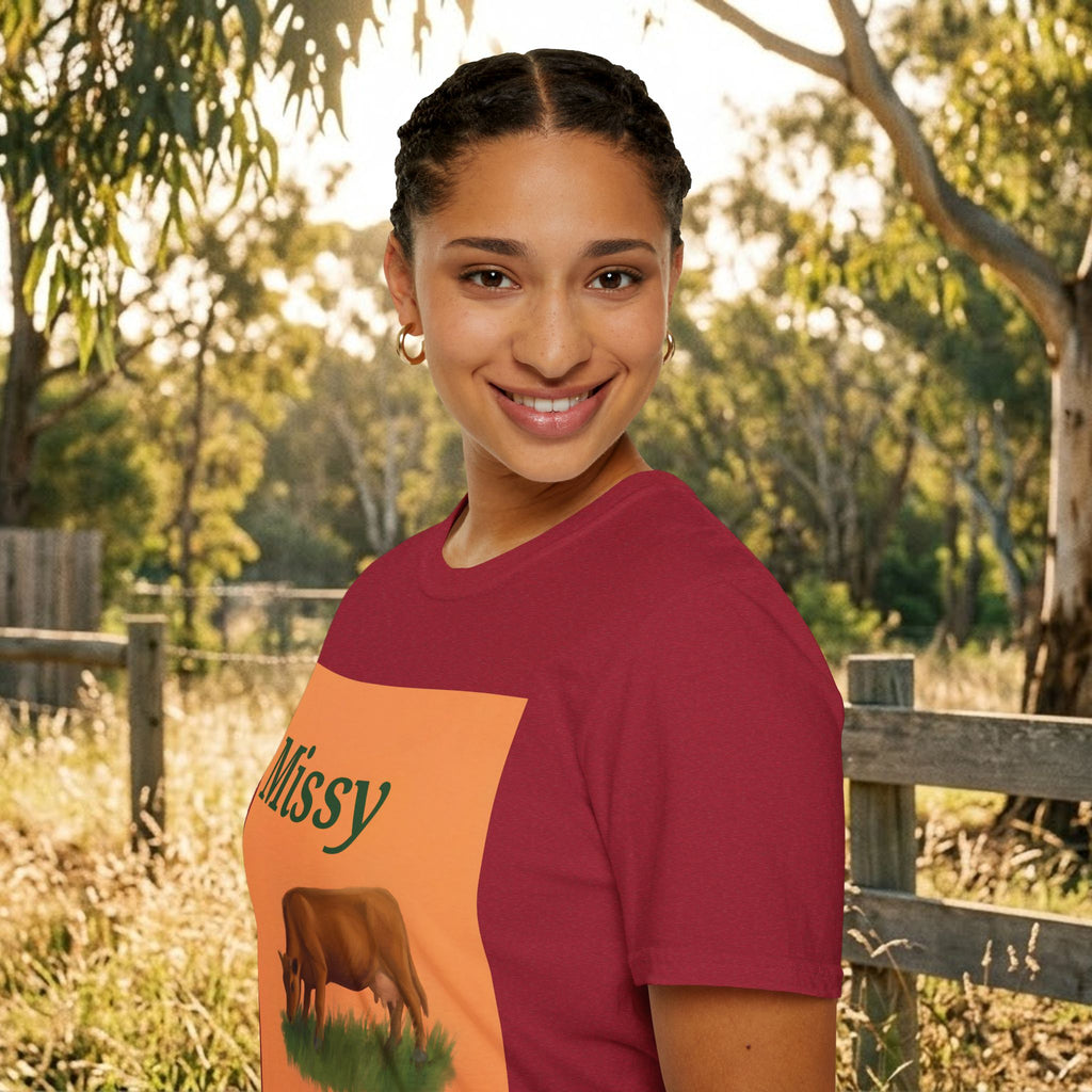 Maroon T-shirt with orange Missy panel and grazing cow graphic, side view