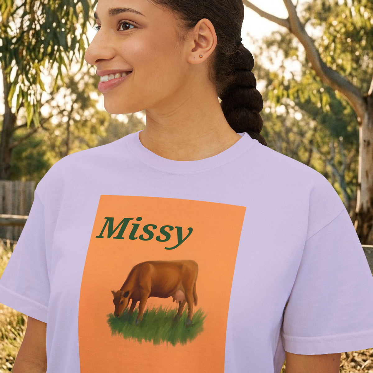 Women’s boxy graphic tee in lavender with 'Missy' cow illustration on front