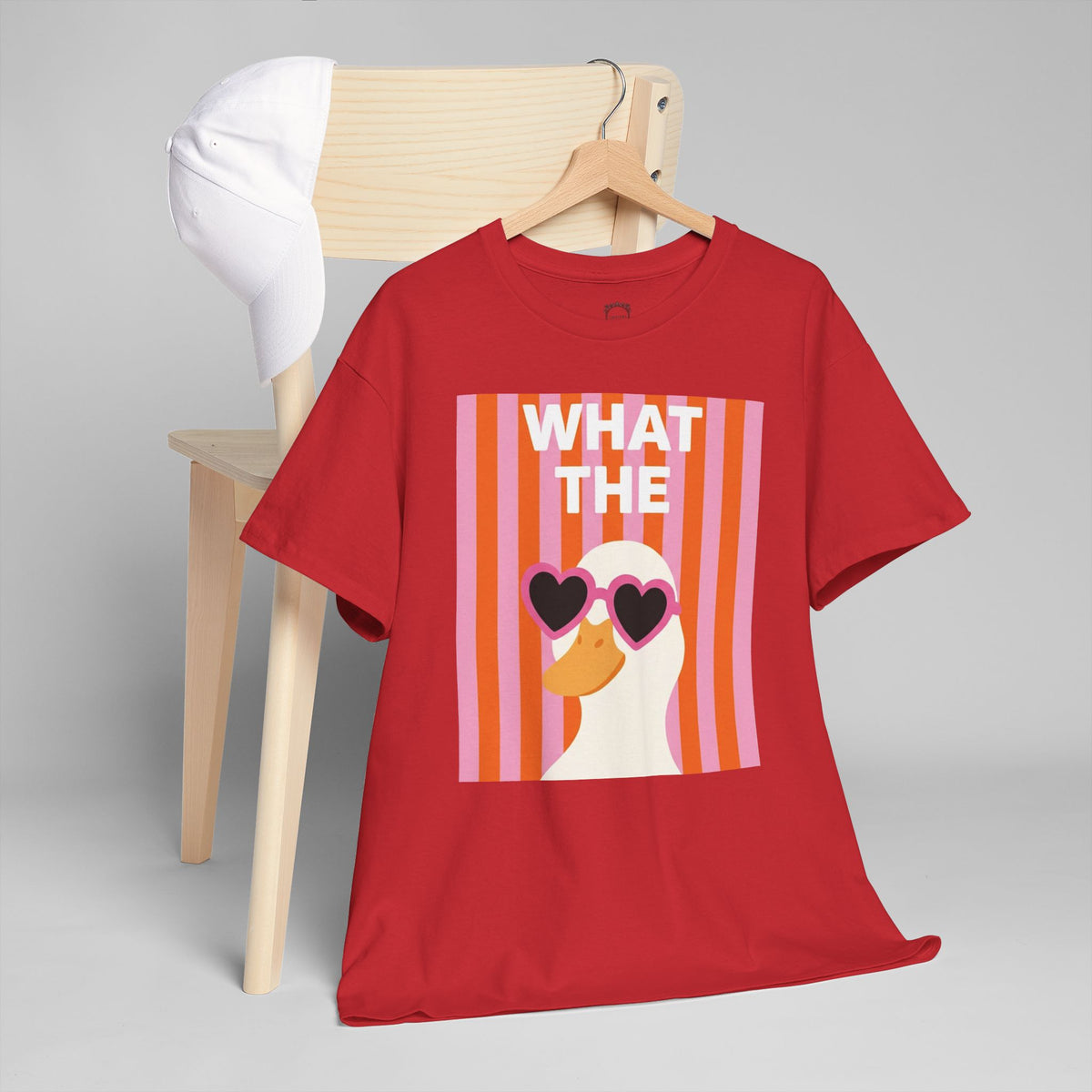Red unisex crewneck T-shirt with “WHAT THE” heart sunglasses graphic front