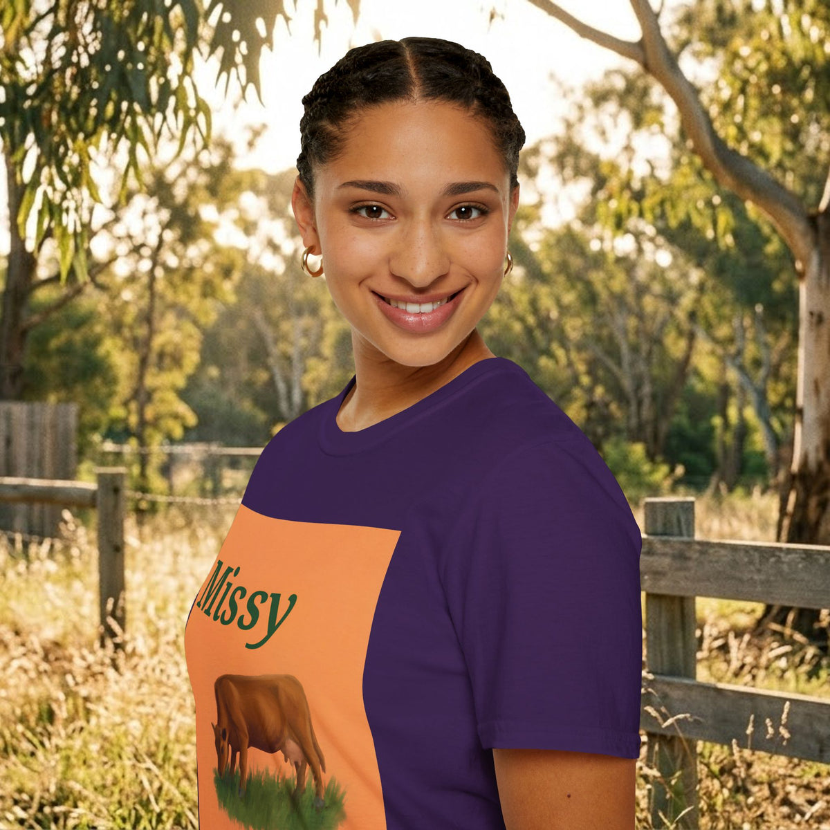 Purple cow graphic t-shirt with orange panel and grazing cow illustration