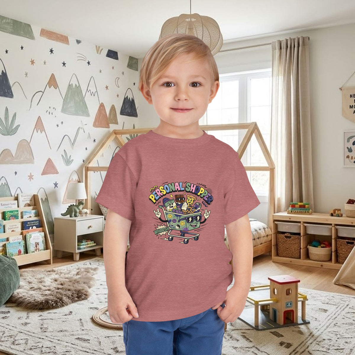 Maroon toddler tee worn by a child, featuring a colorful shopping cart graphic