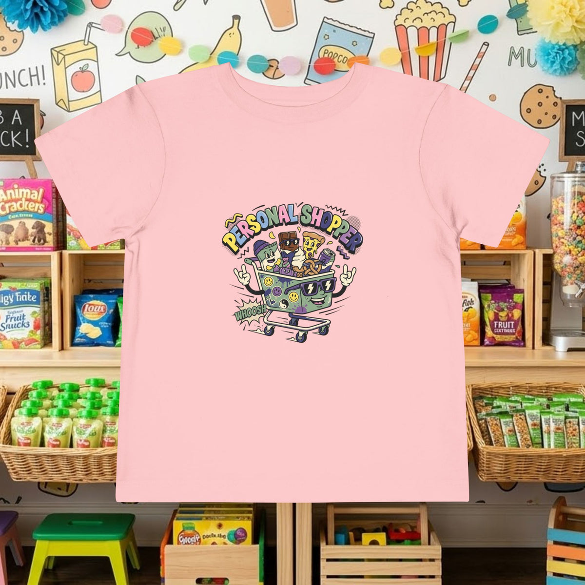 Pink toddler tee with colorful shopping cart graphic and “Personal Shopper” text