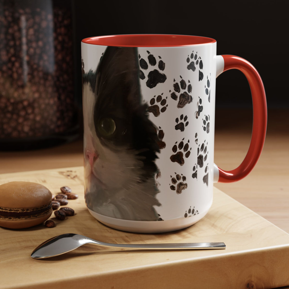 Black cat face accent coffee mug with paw print pattern, white body, red handle