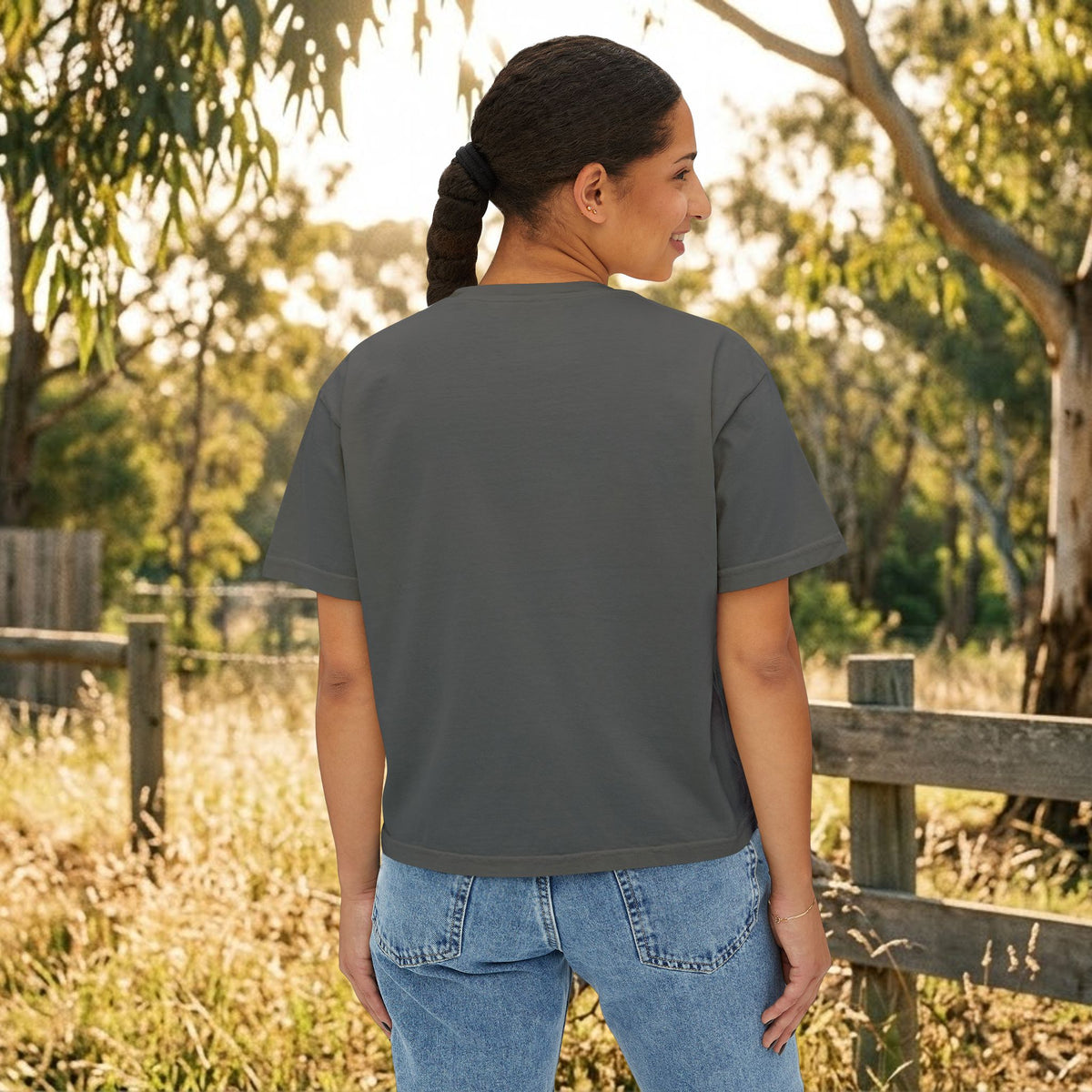 Dark gray boxy T-shirt back view on model, short sleeves and crew neckline.