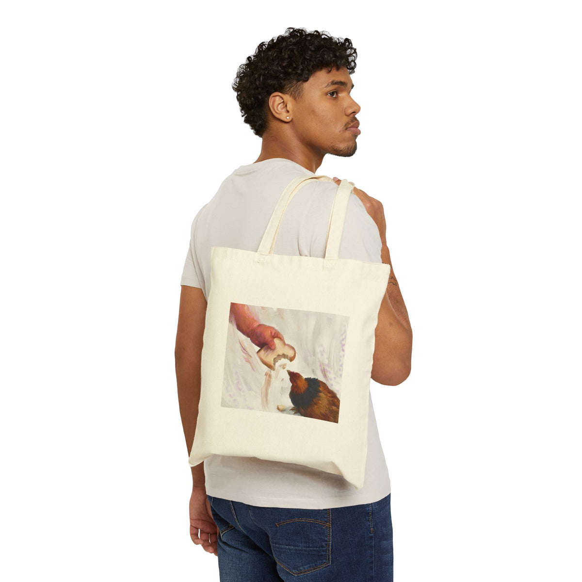 Natural canvas tote bag with vintage hen feeding illustration, worn over the shoulder.